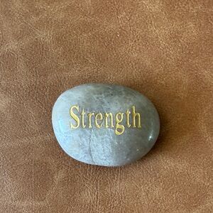 Gray Stone with Gold 'Strength' Inscription Writing Paper Weight 3” by 2”